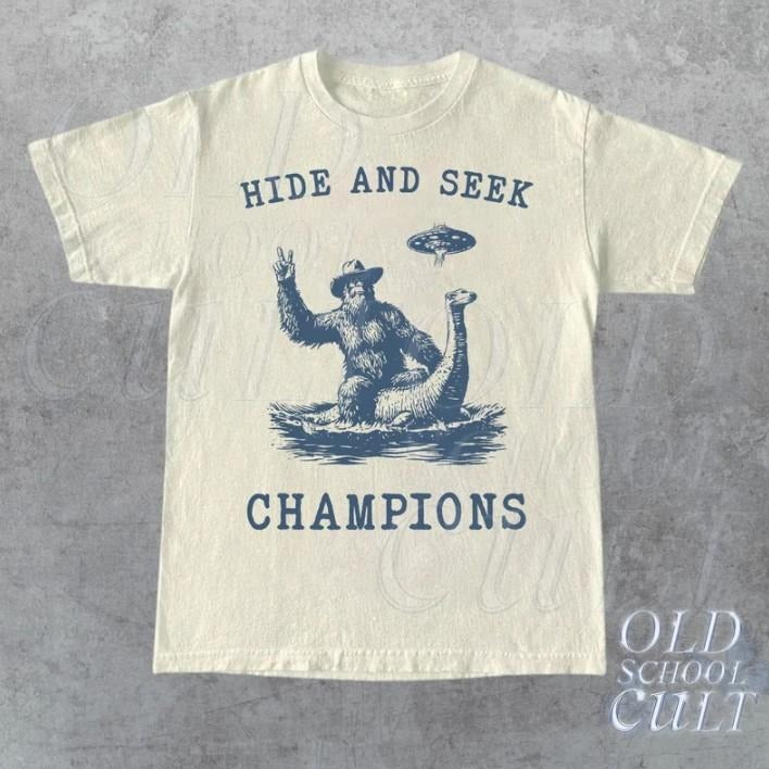 Hide And Seek Ufo Tshirt, Retro Bigfoot Shirt, Bigfoot Riding Dinosaur Shirt Hoodie, Sweatshirt | HypeCrazeTee.com