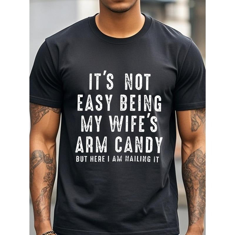 IT'S NOT EASY BEING MY WIFE'S ARM CANDY BUT HERE I AM NAILING IT Funny T-Shirts Crew Neck Casual T-Shirt Mens T-Shirts...