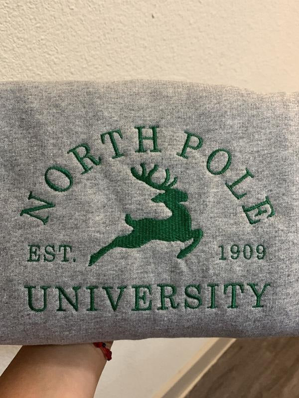 North Pole Embroidered Sweatshirt | Festive Winter Apparel | Cozy Holiday Sweater | Unique Christmas Gift | Embroidered...