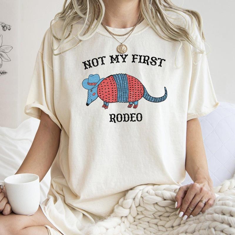 Not My First Rodeo, Cowboy Armadillo, Cute, Tshirt, Women's Crew Neck, Crewneck Hoodie, Sweatshirt | HypeCrazeTee.com