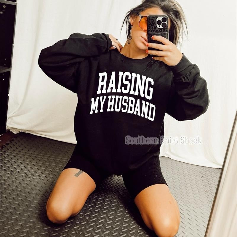 Raising my Husband Sweatshirt | Black Sweatshirt graphic shirt unisex style Hoodie | HypeCrazeTee.com