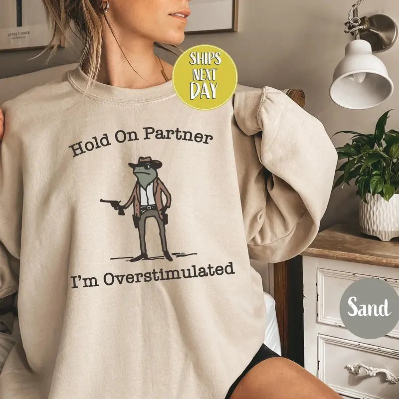 Hold On Partner I'm Overstimulated Cowb0y Fr0g Funny Meme Sweatshirt, Funny Fr0g Western Cowb0y Gift Cotton Unisex...